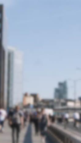 Defocused-Vertical-Video-Pedestrians-Cyclists-Commuting-London-Bridge-Office-Buildings